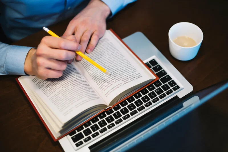crop-man-studying-near-laptop