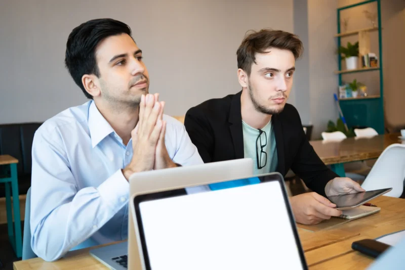 two-professionals-listening-business-conference-speaker