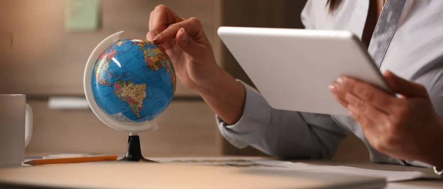 unrecognizable-businesswoman-using-digital-tablet-while-examining-globe-planning-her-vacation unrecognizable-businesswoman-using-digital-tablet-while-examining-globe-planning-her-vacation